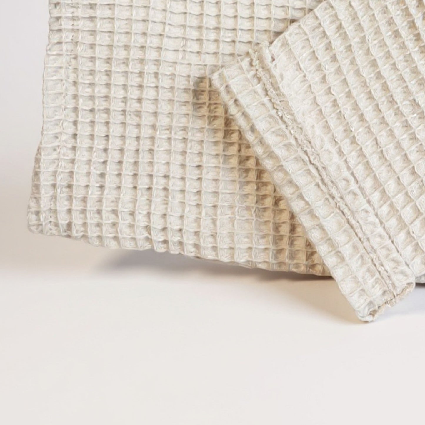 Close-up of a Handmade handwoven waffle design Turkish towel men’s bathrobe in beige and grey, ultra-lightweight and absorbent