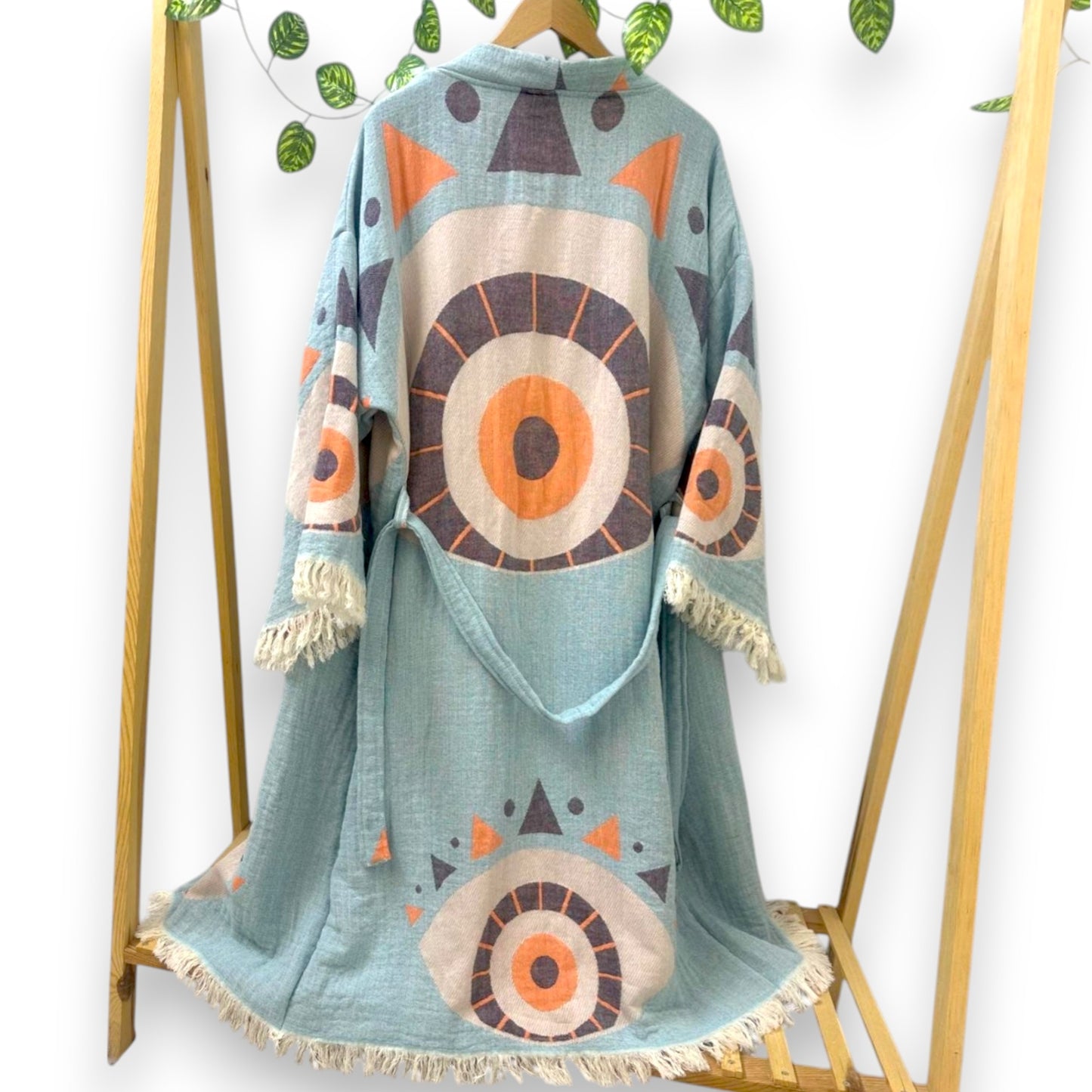 Two kimono robes with Evil Eye patterns in orange and blue colors, displayed on hangers.