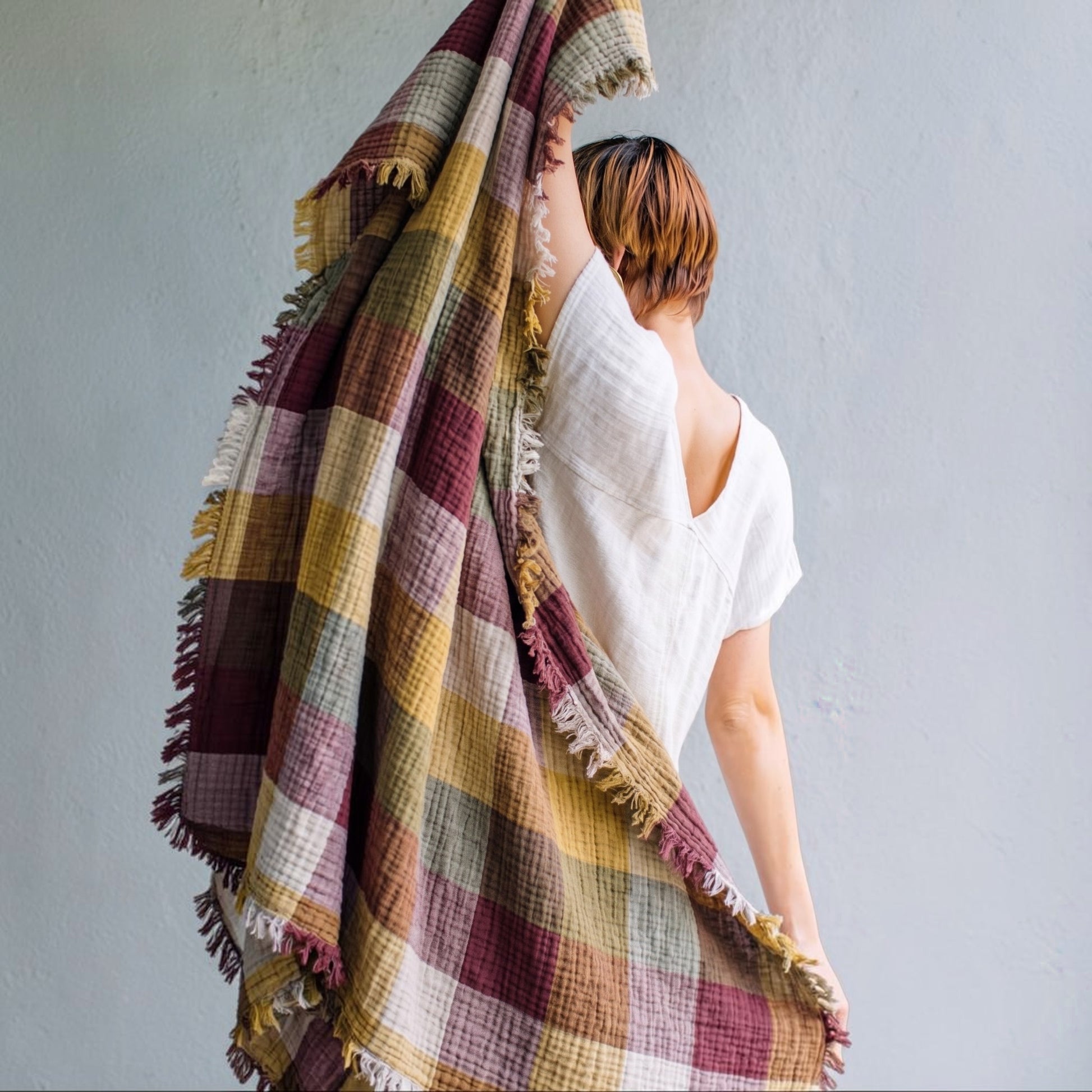 Person holding a Cotton Plaid Throw Blanket – Sofa Throw & Picnic Blanket with a neutral background