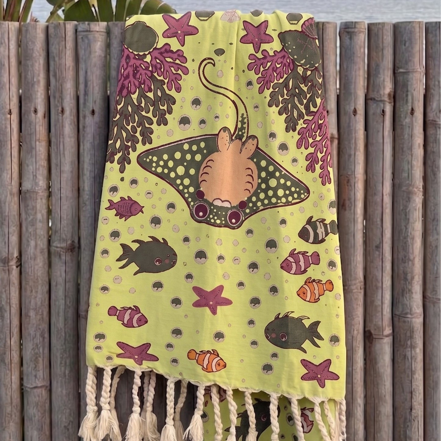 3 layer turkish towel pestemal underwater collection against a wooden fence background