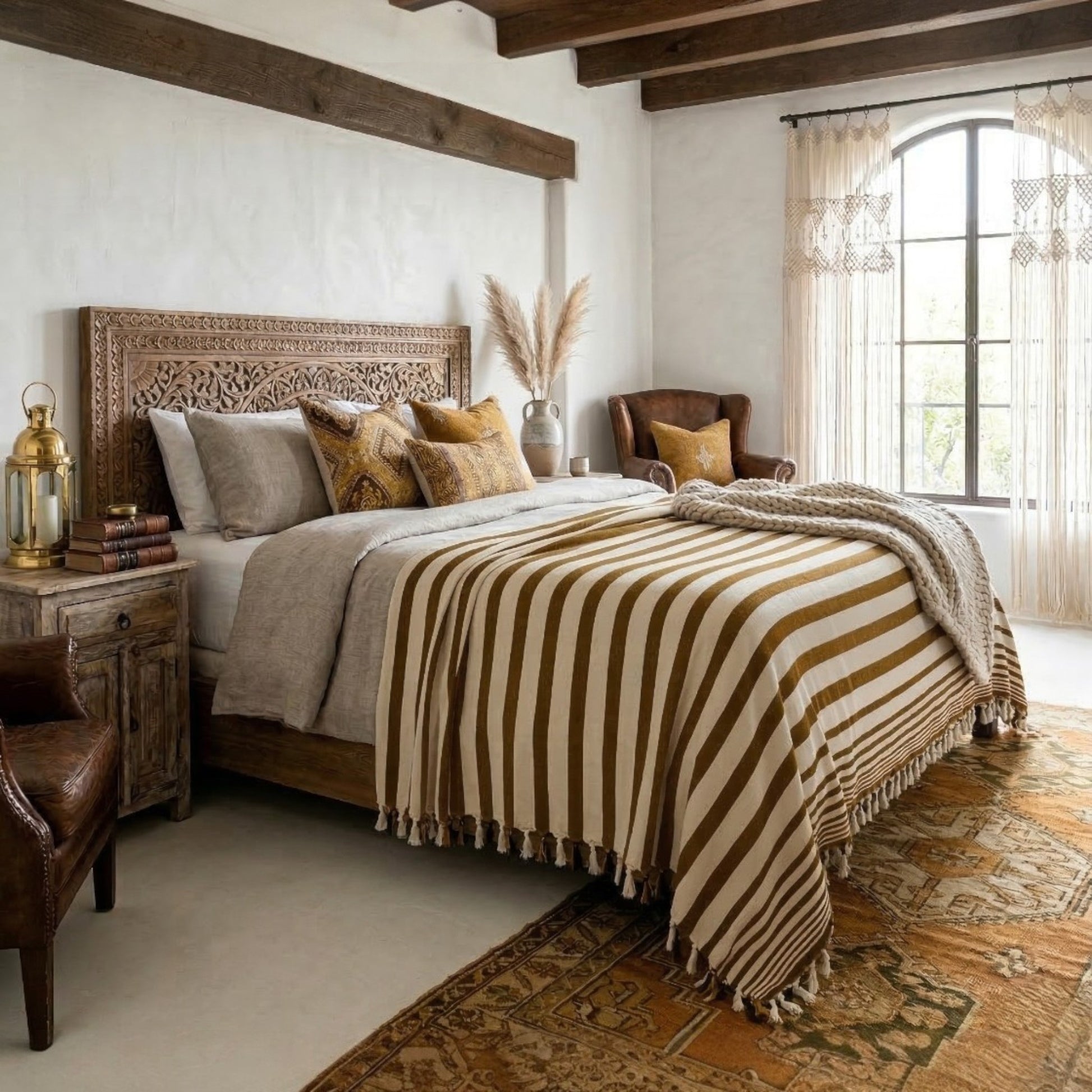 Cozy bedroom with wooden bed, striped mustard blanket, and armchair.