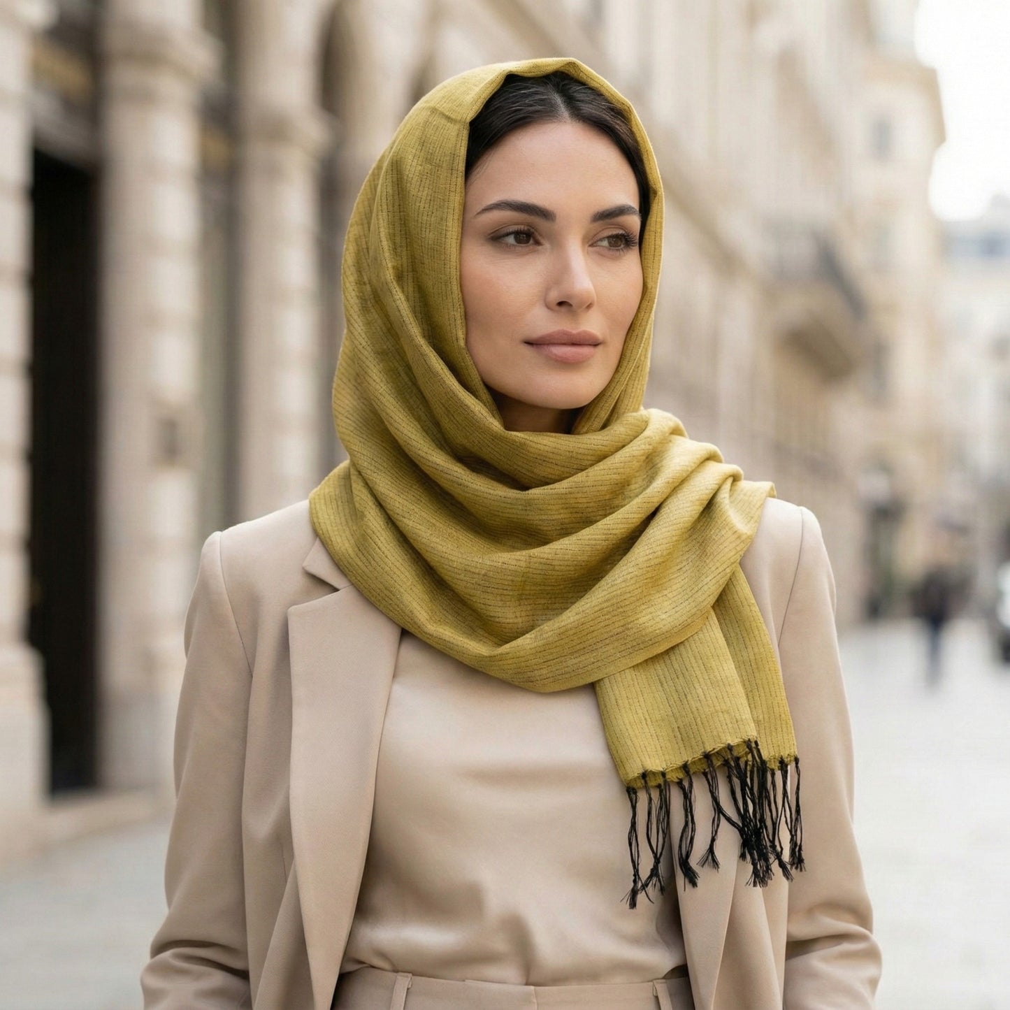 Woman wearing a yellow Antakya Handwoven Silk Scarf in an urban setting