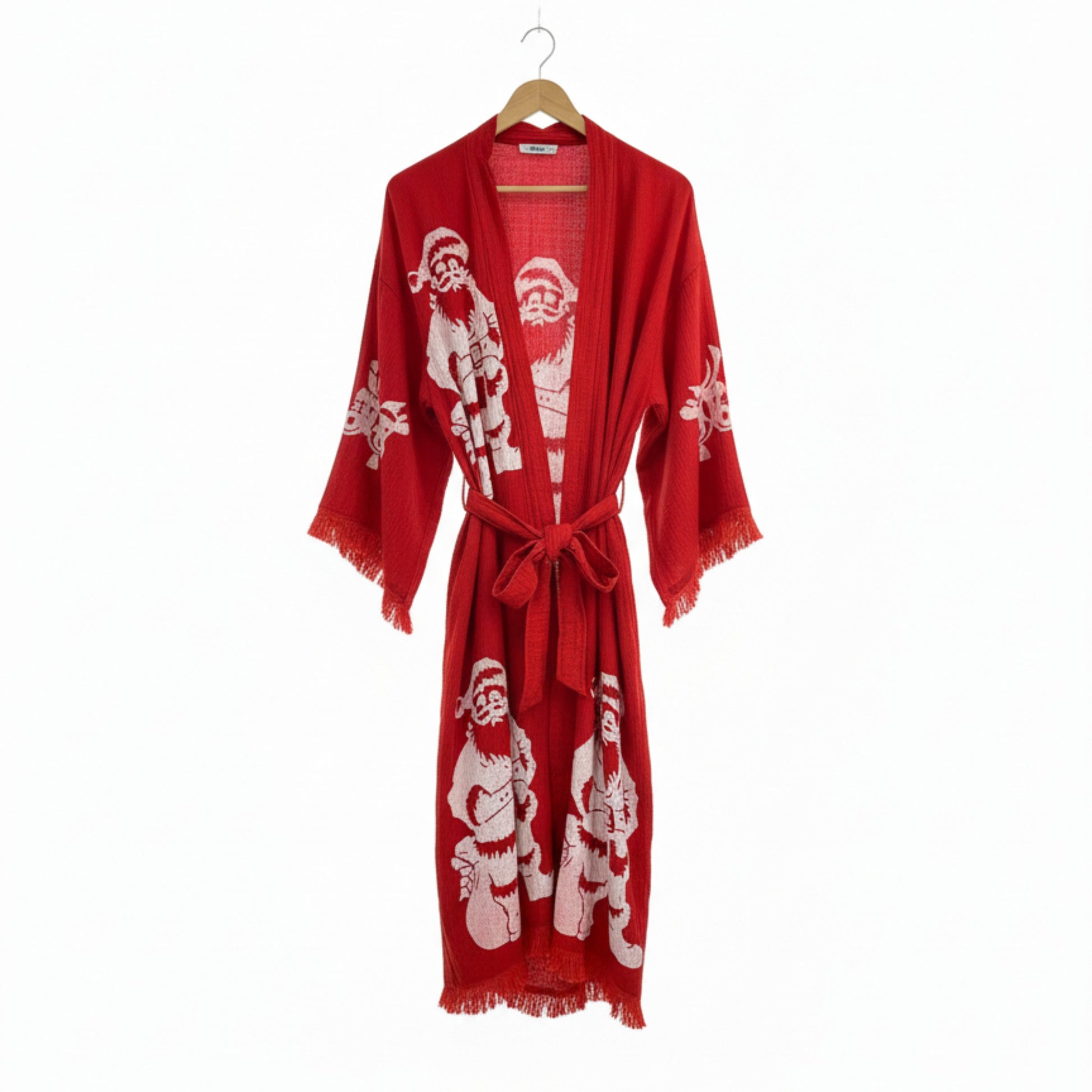 Red robe with Santa Claus pattern on a hanger against a white background