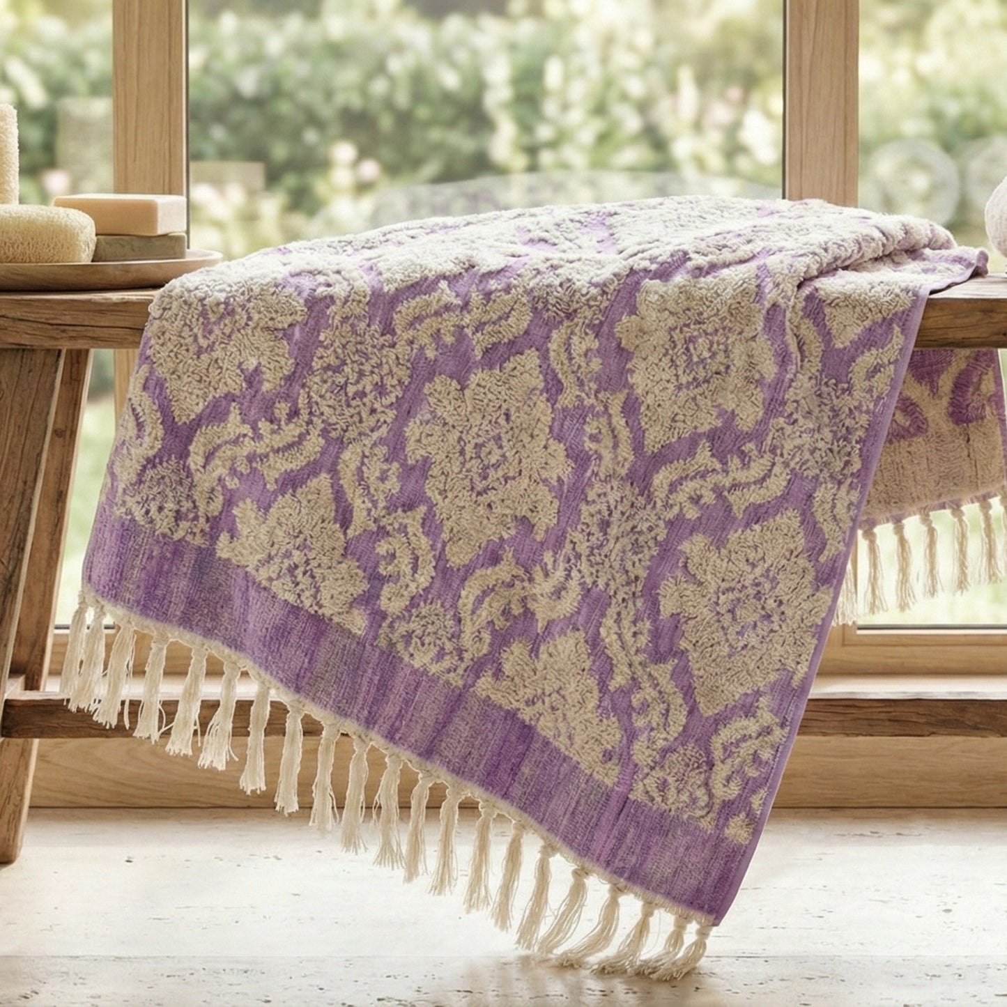Purple and beige Damascus Design Natural Cotton Turkish Terry Bath Towel with fringe on a wooden surface.