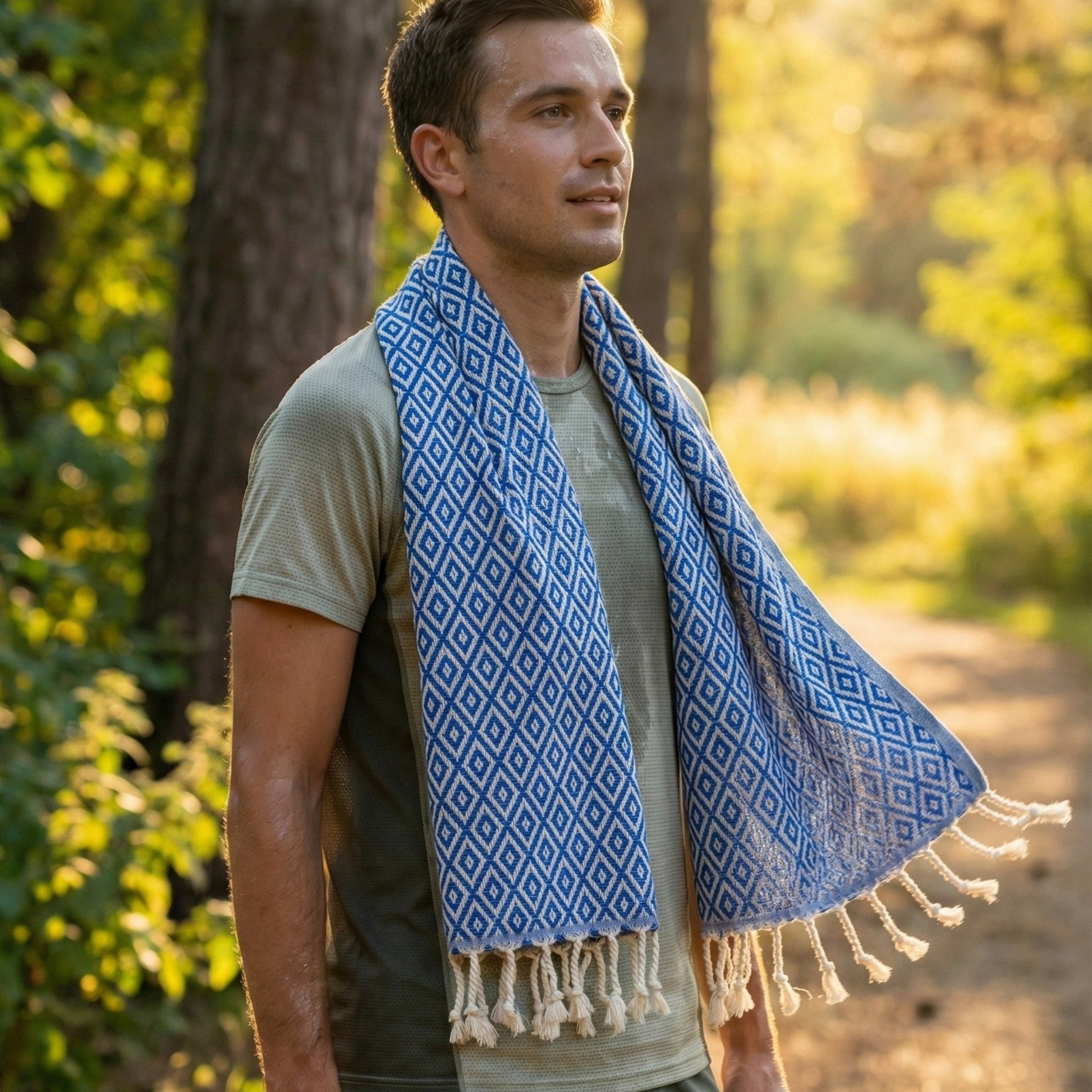 Man wearing a blue patterned Diamond Design Turkish Hand Towel  Handwoven Natural Cotton Sustainable Anatolian Craft in a forest setting