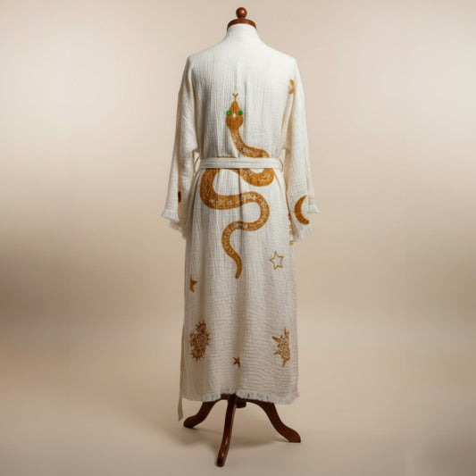 Hand-woven natural cotton muslin kimono robe hanging in a studio setup