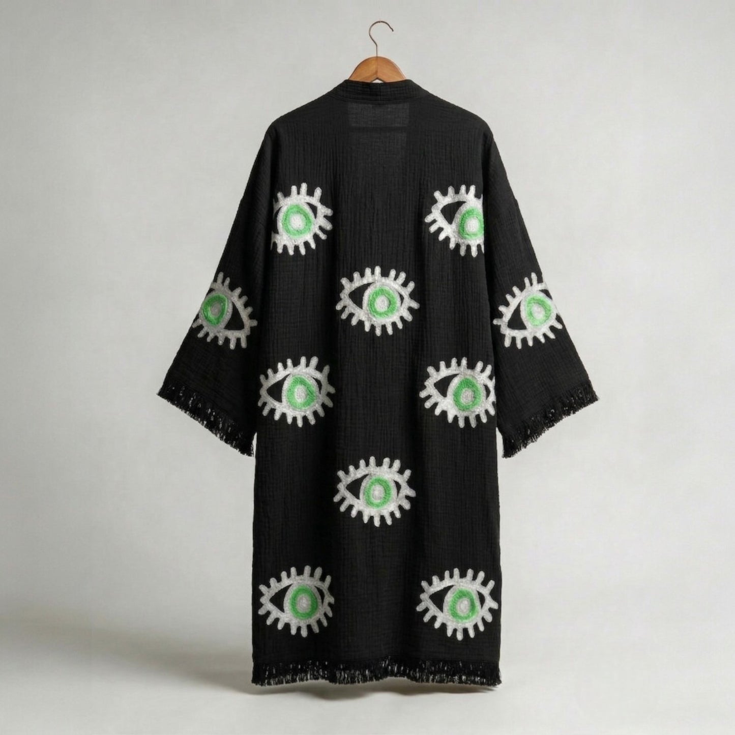 hand woven evil eye turkish cotton kimono robe black on a hanger against a white background