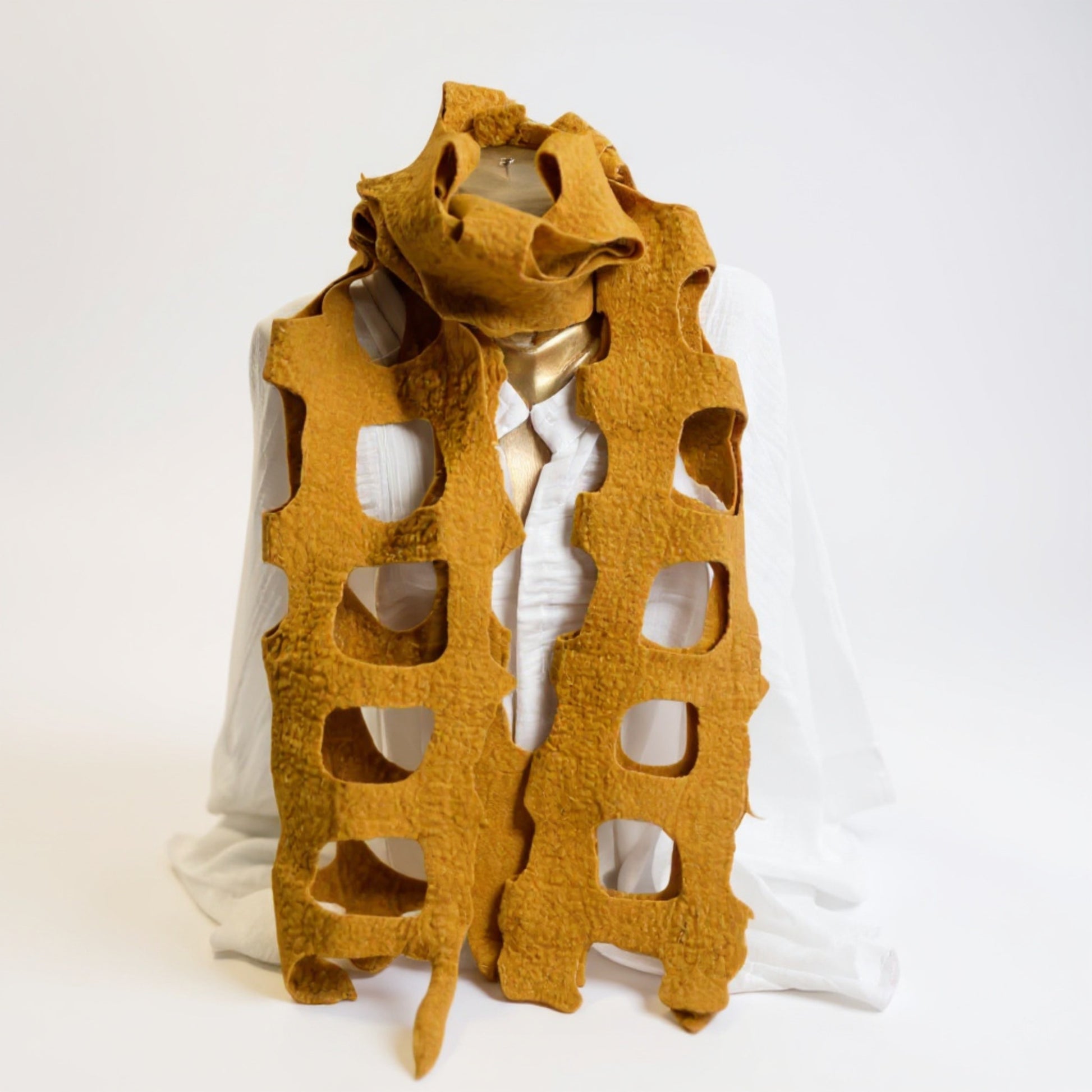 Handmade felted Golden Yellow wool shawl/scarf in golden yellow, displayed on a mannequin with cut-out design, soft textured fabric, 35x95 cm