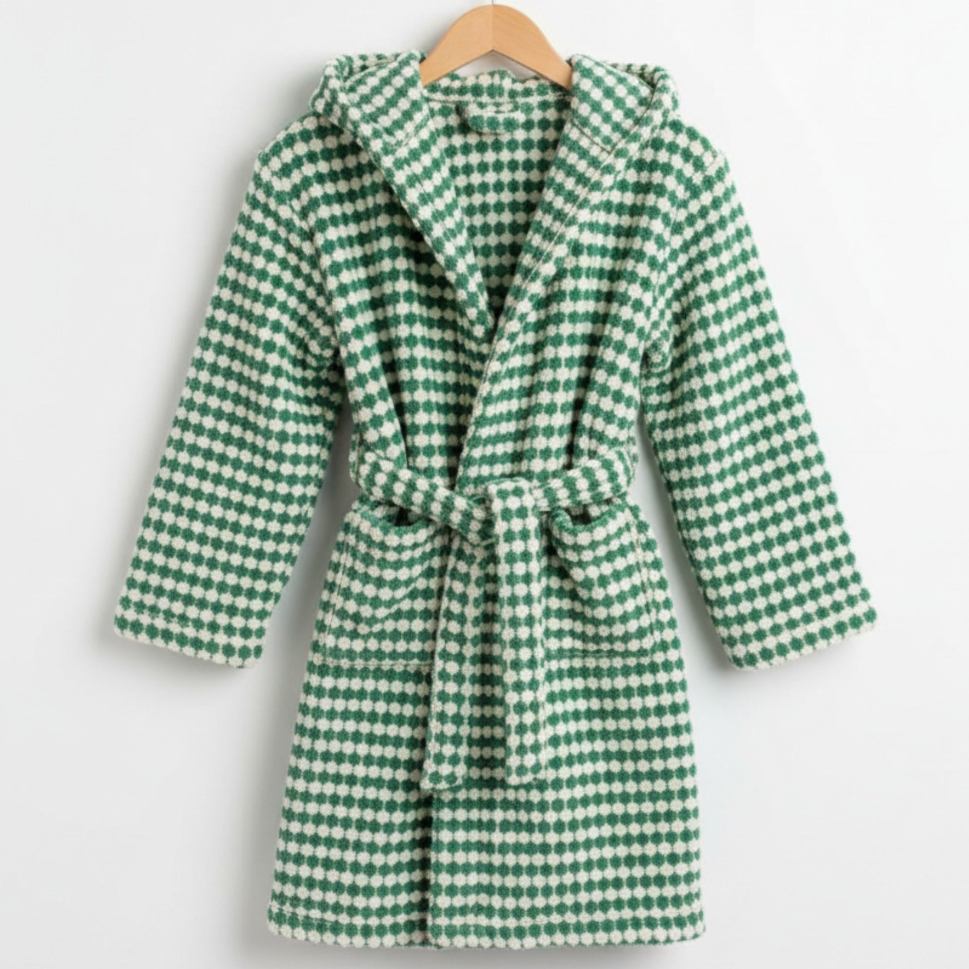 Green and white checkered robe on a hanger against a white background