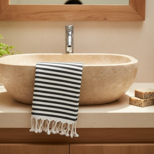 Striped Natural Cotton Traditional Hand Towel draped over a stone sink in a bathroom setting