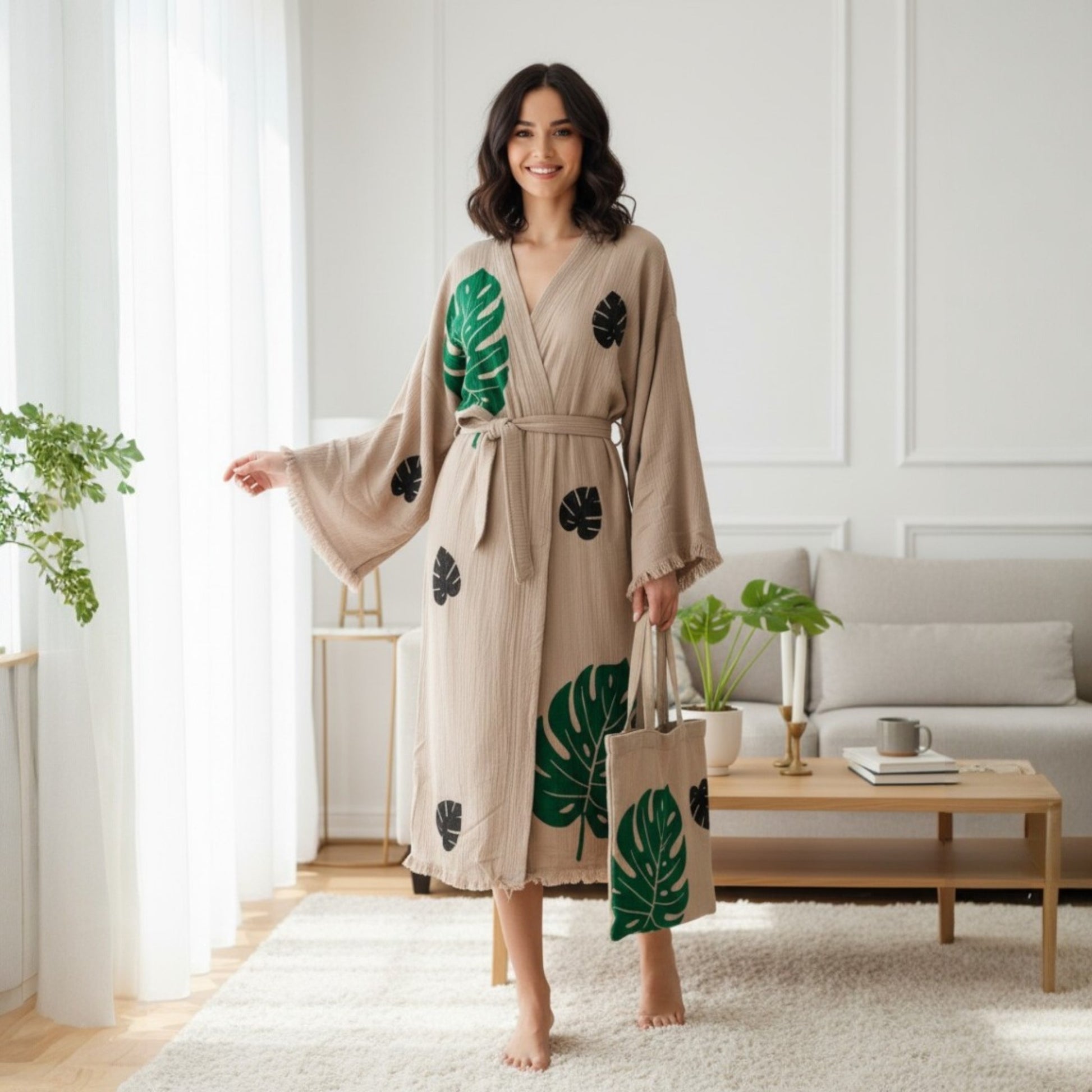 Woman wearing a beige Turkish Towel Kimono Robe – Hand Block Printed Natural Cotton Kimono | Evil Eye Kimono Robe Collection with green leaf patterns in a modern living room.