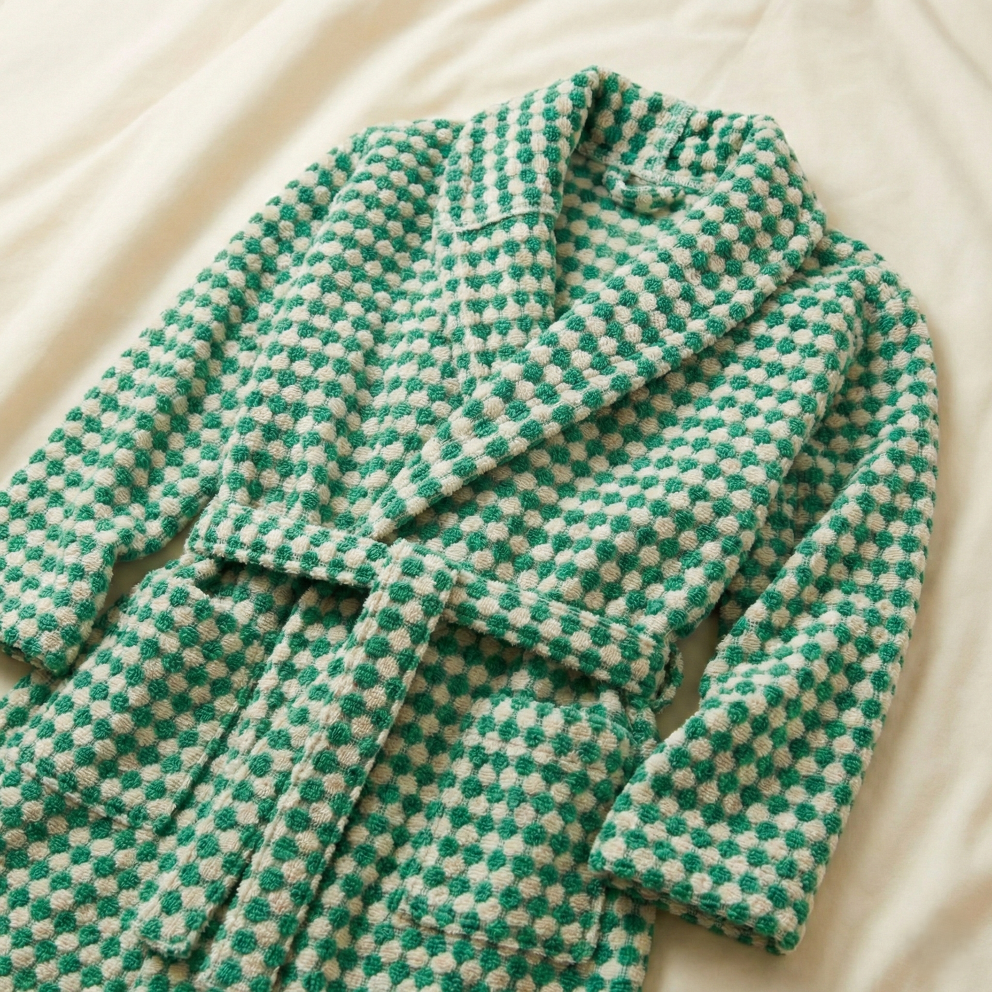 Turkish Terry Towel Bathrobe Green Dotted Pompom Design Shawl Collar robe on a beige surface