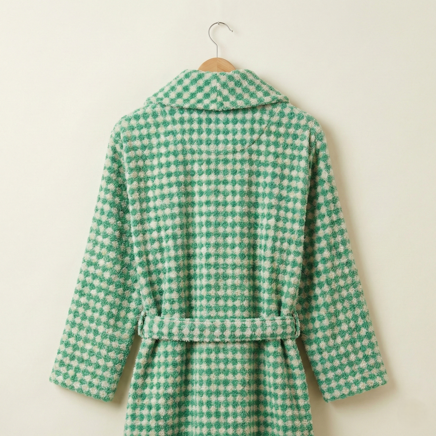 Turkish Terry Towel Bathrobe Green Dotted Pompom Design Shawl Collar robe on a hanger against a beige background