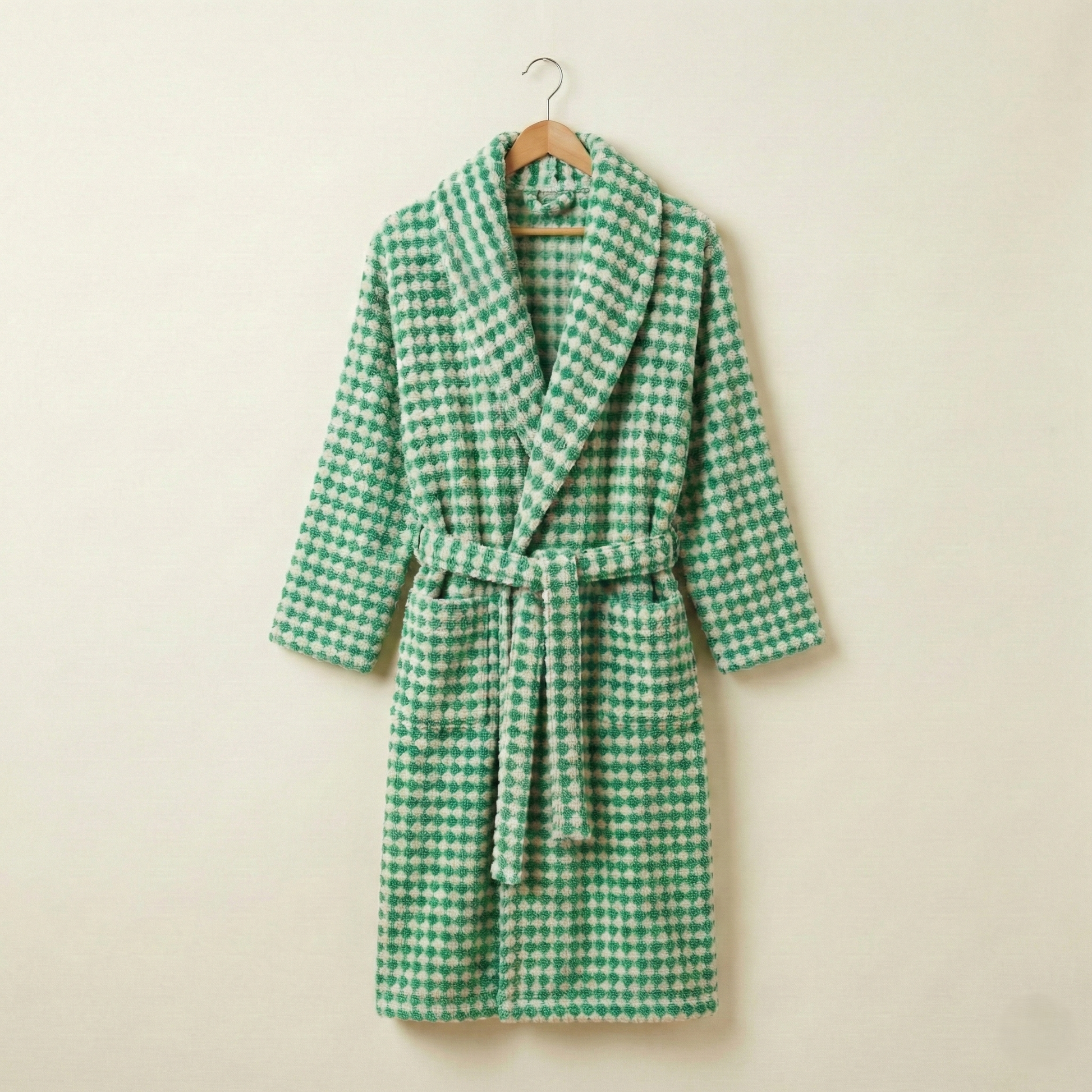 Turkish Terry Towel Bathrobe Green Dotted Pompom Design Shawl Collar robe on a hanger against a beige background
